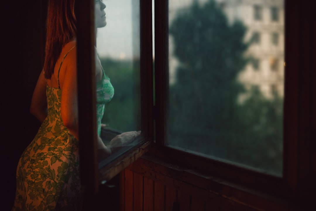 A person stands calmly looking out a bright window, conveying a sense of relief and confidence after finding trustworthy health information.