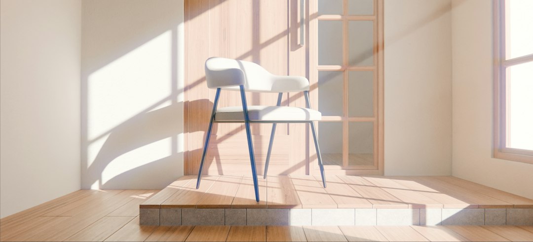 A woman sits on the floor of a sunlit, empty new home, holding her head in her hands to convey the pain of a migraine after the stress of moving.